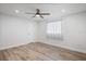 Neutral bedroom features a ceiling fan and plank floors at 7095 Beardsley St, Englewood, FL 34224