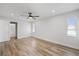 Bedroom showcasing wood-look floors, ensuite bathroom, and natural light at 7095 Beardsley St, Englewood, FL 34224