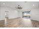 Bright bedroom featuring updated flooring, a ceiling fan, and sliding glass doors leading to the lanai at 7095 Beardsley St, Englewood, FL 34224