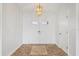 Bright foyer featuring double doors, decorative tile flooring, and a modern chandelier at 7095 Beardsley St, Englewood, FL 34224