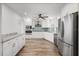 Well-lit kitchen boasts white cabinets, stainless appliances and a breakfast nook at 7095 Beardsley St, Englewood, FL 34224