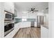 Modern kitchen featuring stainless steel appliances, white cabinets and eat-in space at 7095 Beardsley St, Englewood, FL 34224