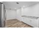 Bright eat-in kitchen area featuring white cabinets, stainless appliances, and modern countertops at 7095 Beardsley St, Englewood, FL 34224