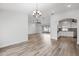 Bright living area with wood floors, arched doorway, and sliding door access to backyard at 7095 Beardsley St, Englewood, FL 34224
