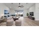 Staged living room featuring updated flooring, a ceiling fan, and sliding glass doors leading to the lanai at 7095 Beardsley St, Englewood, FL 34224