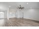 Spacious living room with new flooring and modern ceiling fan, flowing into the entryway at 7095 Beardsley St, Englewood, FL 34224