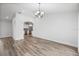 Spacious living room featuring wood-look floors and stylish chandelier at 7095 Beardsley St, Englewood, FL 34224