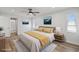 Staged main bedroom featuring wood-look floors, neutral decor and ensuite bathroom at 7095 Beardsley St, Englewood, FL 34224