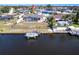 Aerial view of property with a canal-side boat dock and a screened-in pool area at 806 W Ellicott Cir, Port Charlotte, FL 33952