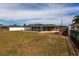 View of the large backyard, featuring a screened in pool and storage shed at 806 W Ellicott Cir, Port Charlotte, FL 33952