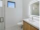 Bright bathroom featuring modern sink, illuminated mirror, glass shower and a compact window for natural light at 9493 St Paul Dr, Port Charlotte, FL 33981