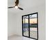 Bedroom featuring a modern ceiling fan and glass doors overlooking a waterfront view at 9493 St Paul Dr, Port Charlotte, FL 33981