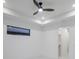 Bright bedroom with a modern ceiling fan and a view into a walk-in closet at 9493 St Paul Dr, Port Charlotte, FL 33981