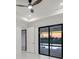 Bedroom with a ceiling fan and sliding glass doors open to the pool area at 9493 St Paul Dr, Port Charlotte, FL 33981