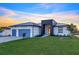 Beautiful home with modern architecture, well-manicured lawn, and a two-car garage in a lovely neighborhood at 9493 St Paul Dr, Port Charlotte, FL 33981