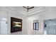 A well-lit living room featuring modern design, linear lighting, and a ceiling fan for optimal comfort at 9493 St Paul Dr, Port Charlotte, FL 33981