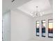 Sunlit living room featuring a modern chandelier and scenic water views at 9493 St Paul Dr, Port Charlotte, FL 33981