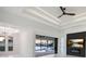 An airy room with a sleek ceiling fan, linear lighting, and sliders to a canal view at 9493 St Paul Dr, Port Charlotte, FL 33981