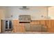 Outdoor kitchen featuring stainless steel grill, beverage cooler, counter space, and storage at 9493 St Paul Dr, Port Charlotte, FL 33981