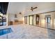 Outdoor living space with a grill, a pool, ceiling fans, and views of the interior space at 9493 St Paul Dr, Port Charlotte, FL 33981