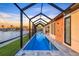 Inviting pool area with a screened enclosure, offering relaxing water views and sun protection at 9493 St Paul Dr, Port Charlotte, FL 33981