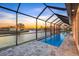 Screened-in pool offering stunning water views, perfect for relaxation and outdoor enjoyment at 9493 St Paul Dr, Port Charlotte, FL 33981