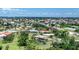 Beautiful aerial view of a waterfront community with lush greenery and stunning ocean views in the background at 1315 Santiago Ct, Punta Gorda, FL 33950