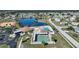 Aerial view of the community pool, clubhouse, tennis courts and shuffleboard at 13632 Clara Ln, Port Charlotte, FL 33981