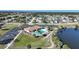 Aerial view of the community pool, clubhouse and adjacent lake at 13632 Clara Ln, Port Charlotte, FL 33981
