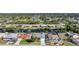 Aerial view of canal-front homes with fenced yards and mature trees at 13632 Clara Ln, Port Charlotte, FL 33981