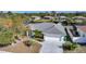 Aerial view of home highlighting lush landscaping, and a spacious driveway for parking at 13632 Clara Ln, Port Charlotte, FL 33981