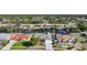 Aerial view of canal-front homes with mature trees and lush landscaping at 13632 Clara Ln, Port Charlotte, FL 33981