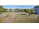 Large grassy backyard with canal waterfront and mature landscaping at 13632 Clara Ln, Port Charlotte, FL 33981