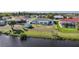 Home with canal view, lush grass, privacy, and well maintained lawn at 13632 Clara Ln, Port Charlotte, FL 33981