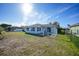 The backyard has a covered patio and partially fenced in yard at 13632 Clara Ln, Port Charlotte, FL 33981