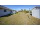 Sprawling backyard featuring a pond and white storage shed at 13632 Clara Ln, Port Charlotte, FL 33981