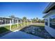 Backyard view with a stepping stone path and a screened-in lanai overlooking the water at 13632 Clara Ln, Port Charlotte, FL 33981