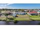 Home with canal view, showcasing well-maintained lawn and privacy at 13632 Clara Ln, Port Charlotte, FL 33981
