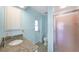 Cozy bathroom with granite vanity top, tiled flooring, and a glass-enclosed shower at 13632 Clara Ln, Port Charlotte, FL 33981