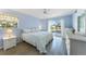 Bright bedroom with neutral walls, ceiling fan, and sliding glass doors at 13632 Clara Ln, Port Charlotte, FL 33981