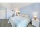 Bedroom with wood-look floors, ceiling fan and ensuite bathroom at 13632 Clara Ln, Port Charlotte, FL 33981