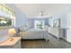 Well-lit bedroom with neutral walls, ceiling fan, and sliding glass doors at 13632 Clara Ln, Port Charlotte, FL 33981