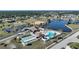 Aerial view of tennis, shuffleboard, pool, and clubhouse, offering resort-style living at 13632 Clara Ln, Port Charlotte, FL 33981
