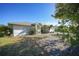 Exterior front elevation of a single-story home with mature landscaping at 13632 Clara Ln, Port Charlotte, FL 33981