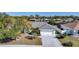 Charming home with a concrete driveway, well-maintained lawn and mature trees at 13632 Clara Ln, Port Charlotte, FL 33981