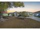 Beautiful sunset view of a charming home with well-maintained landscaping and a welcoming entrance at 13632 Clara Ln, Port Charlotte, FL 33981