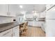 Updated kitchen with white cabinets, granite countertops, and stainless steel appliances at 13632 Clara Ln, Port Charlotte, FL 33981