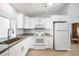 Modern kitchen with white cabinets, granite countertops, and stainless steel appliances at 13632 Clara Ln, Port Charlotte, FL 33981