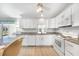Bright kitchen with white cabinets, granite countertops, and modern appliances at 13632 Clara Ln, Port Charlotte, FL 33981