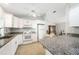 Bright kitchen features granite counters, white cabinets and modern appliances at 13632 Clara Ln, Port Charlotte, FL 33981